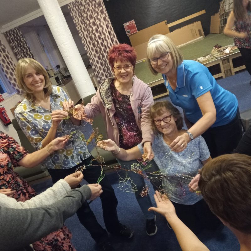 Women creating wire sculpture